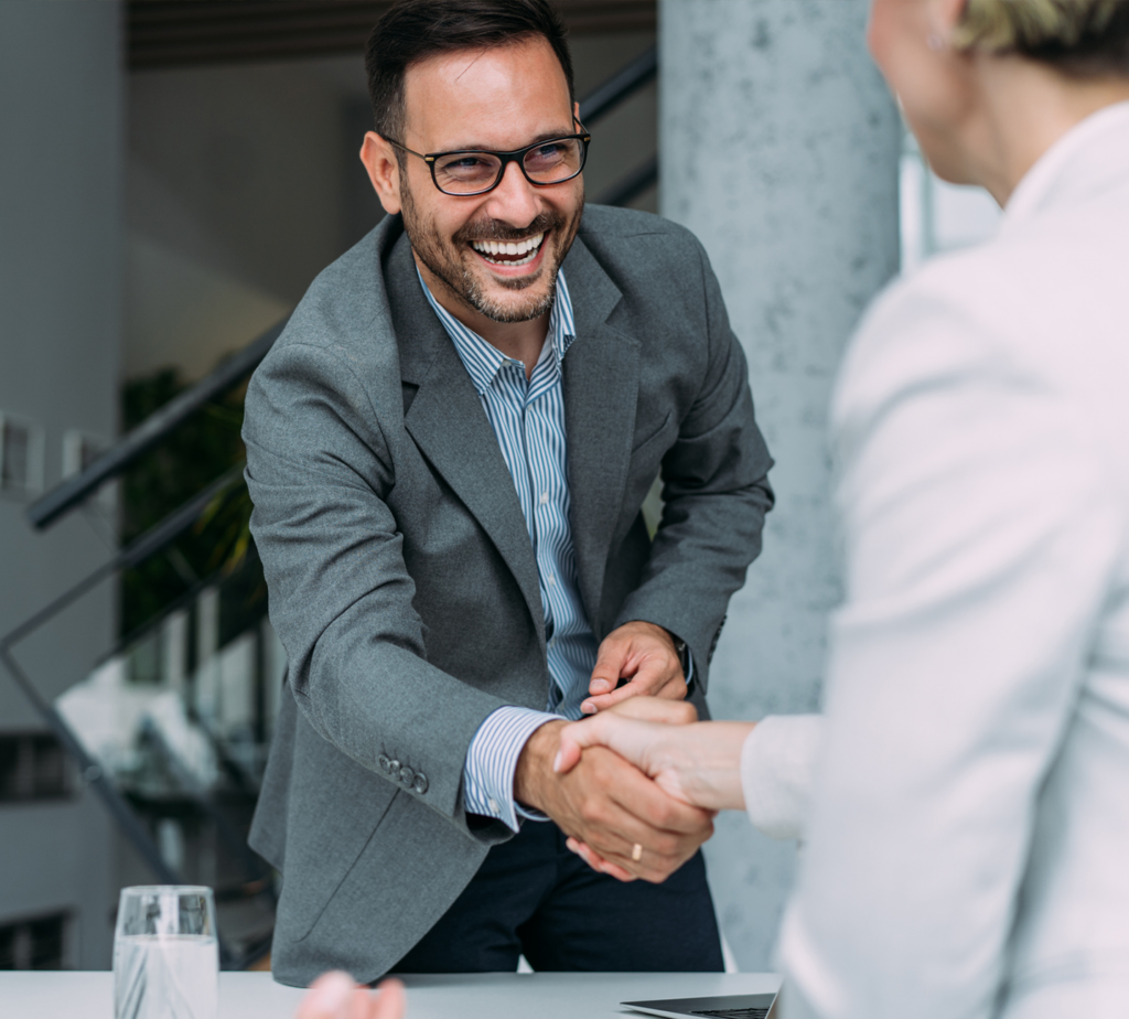 man shaking hands with a woman