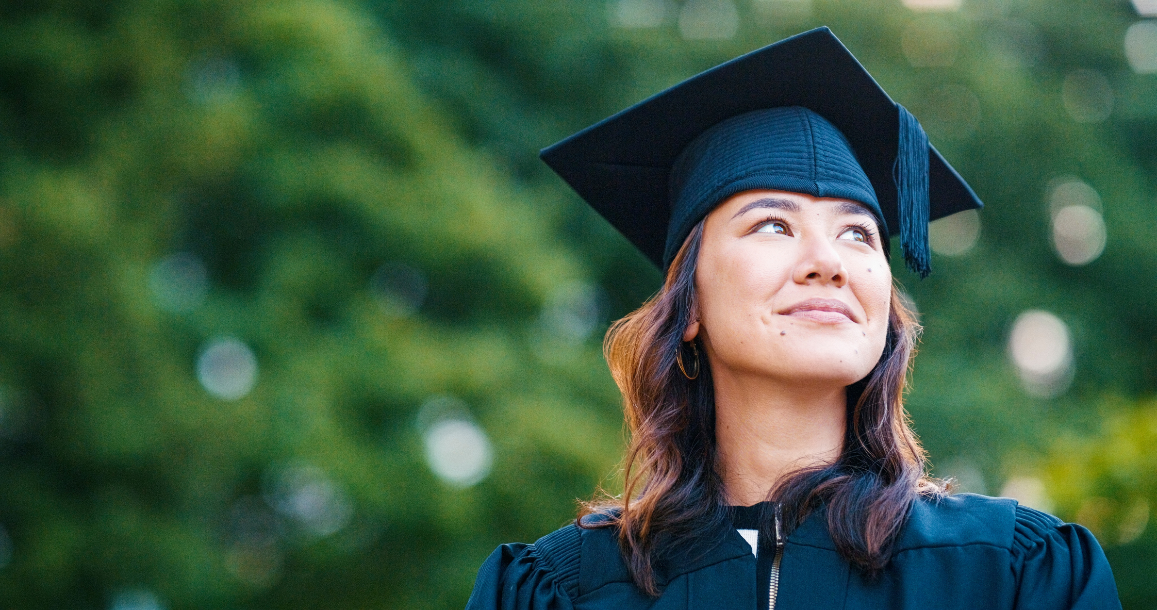 college student outside wearing cap and gown