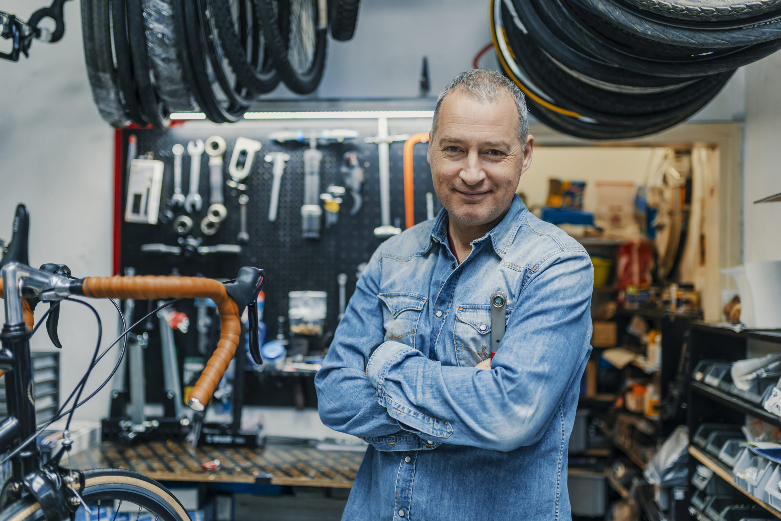 A business man standing in front of his tools and equipment