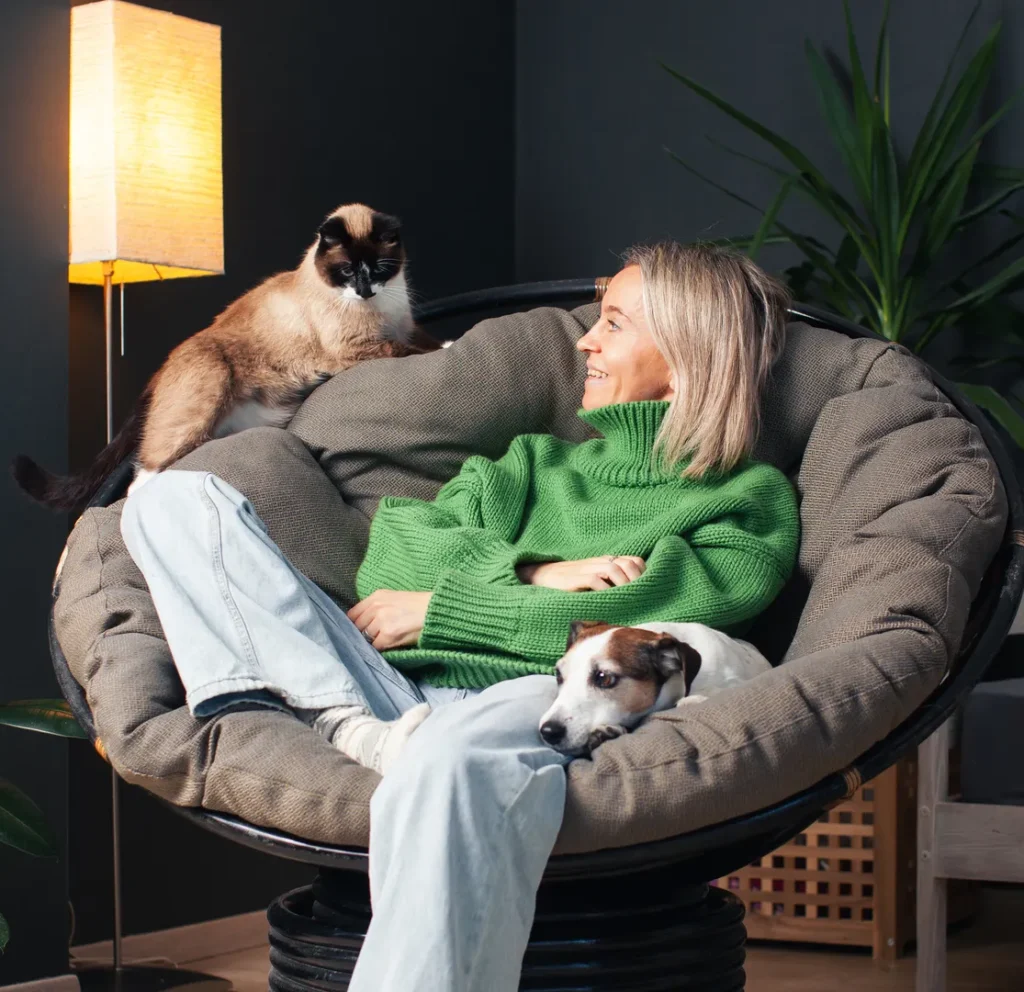 Woman relaxing at home with her pets.